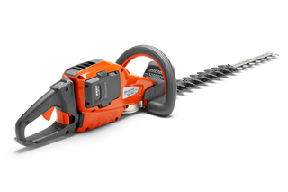 Side view of a Husqvarna hedge trimmer with visible battery compartment.